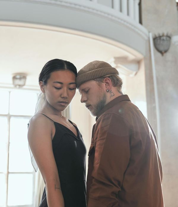 Woman performing a gentle and flowing yoga pose indoors.